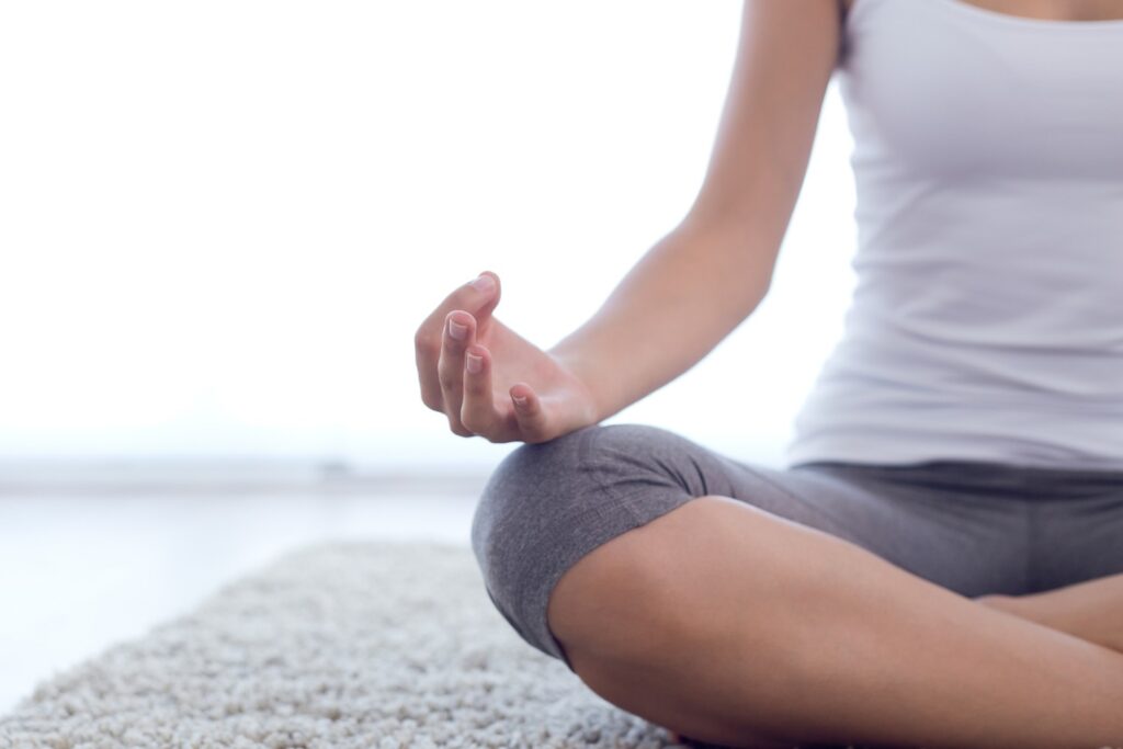 Mindfulness meditation - woman sitting cross legged