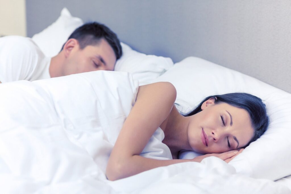 Meditation Benefits - Woman and man lying resting in bed