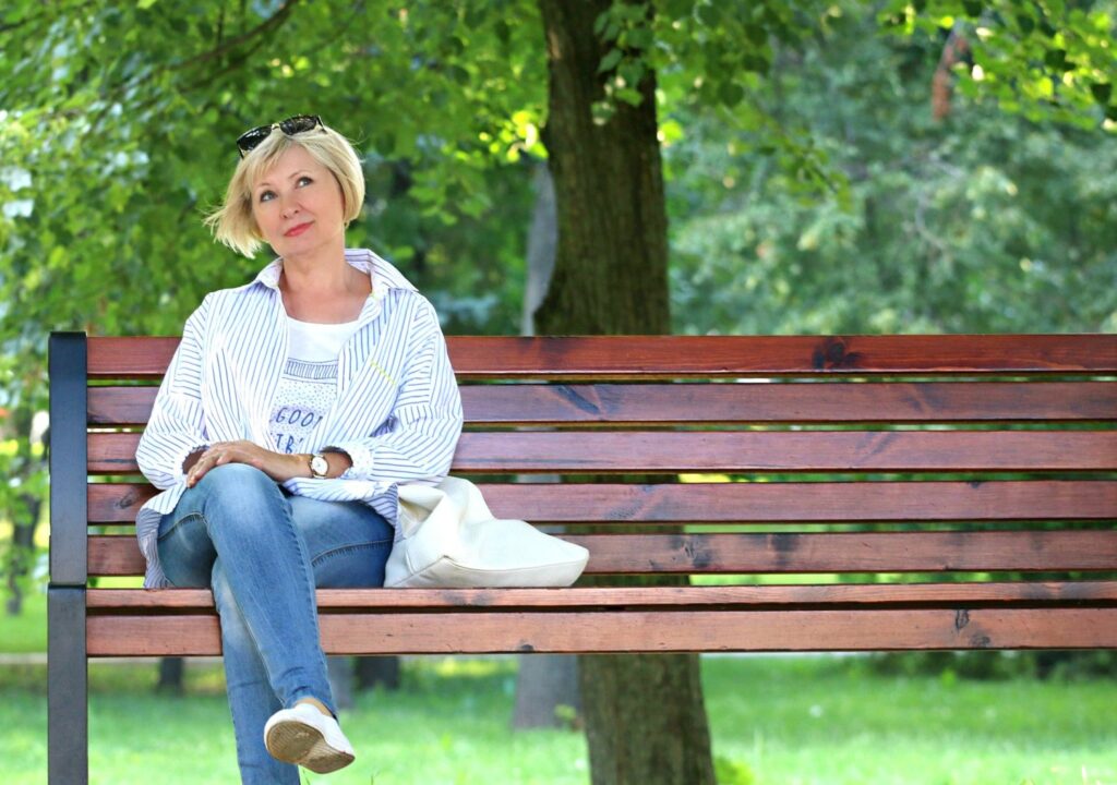 Quiet place - Woman sitting on park bench