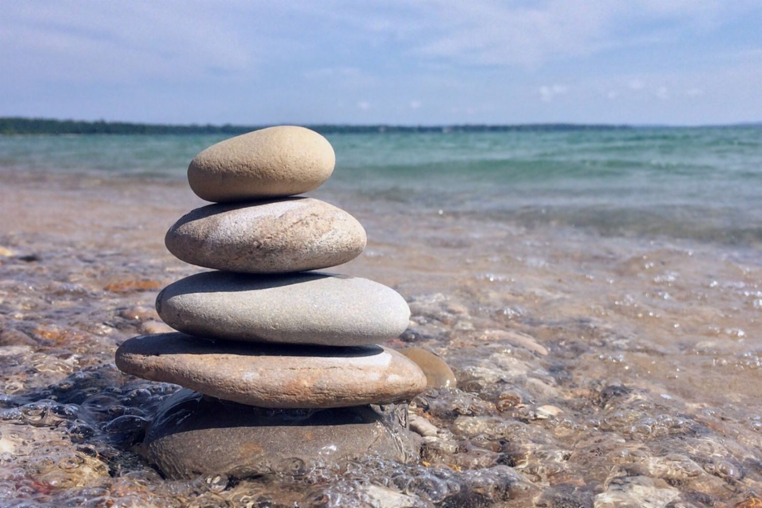 What are 5 ways that you can practice mindfulness - Stack of 5 stones on beach