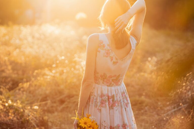 How mindfulness can help you - Woman with flowers in hand in nature with sunset light